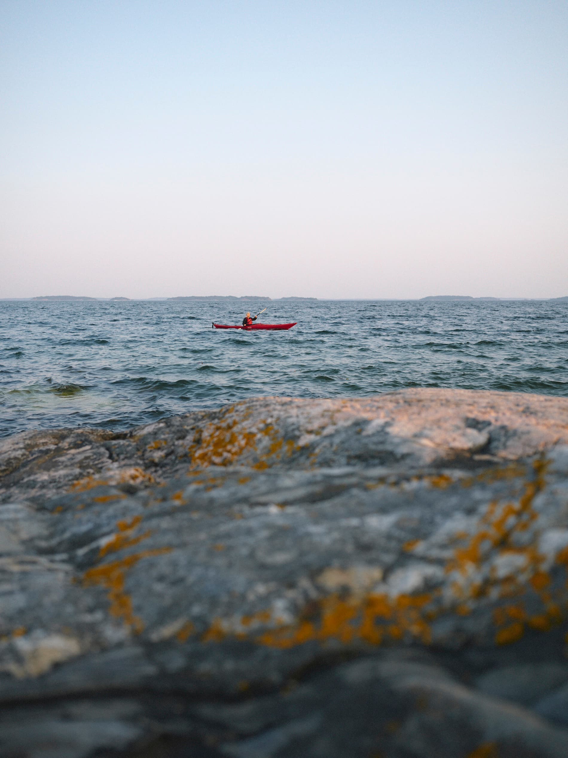 Elle paddling her kayak in the distance