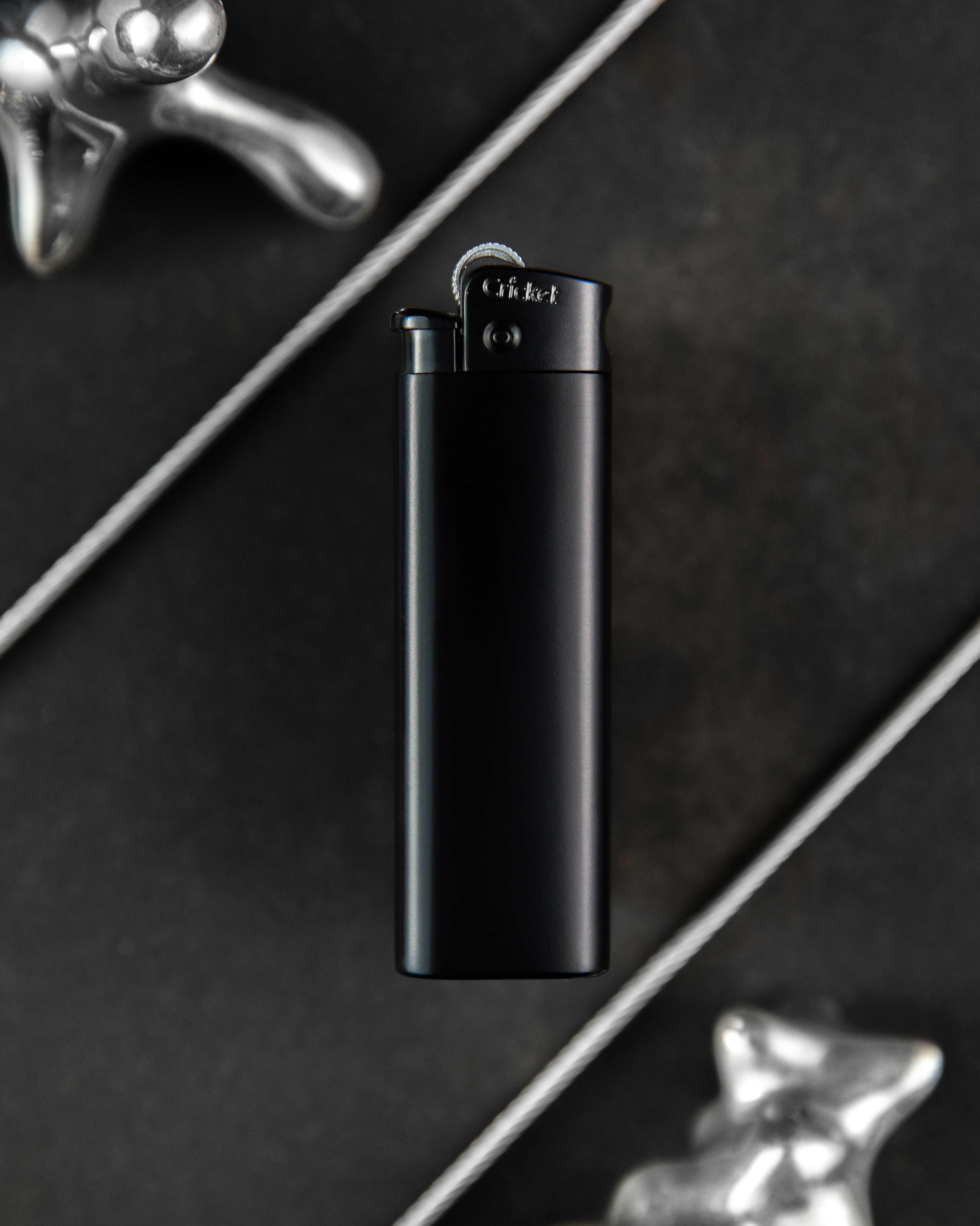 A matte black Cricket metal lighter