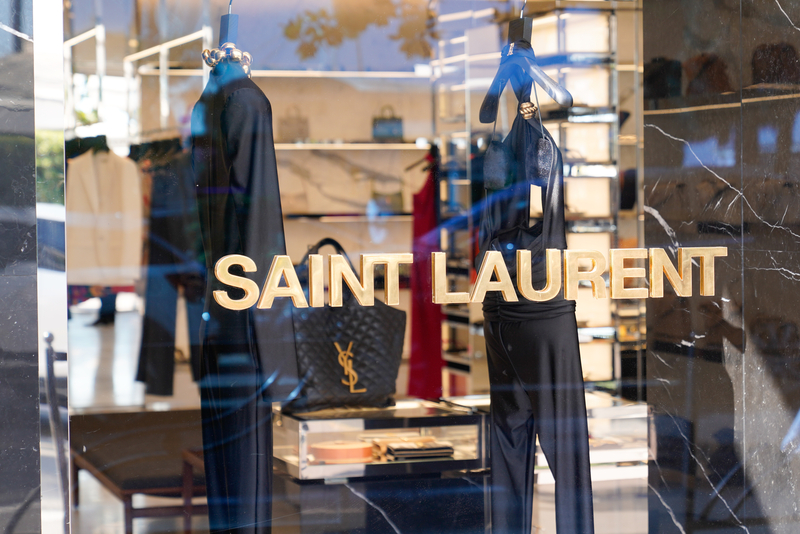  Yves Saint Laurent shop text sign and logo brand on luxury fashion house from Paris, France